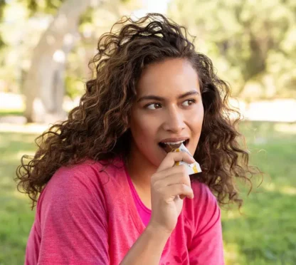 woman eating Herbalife protein bar